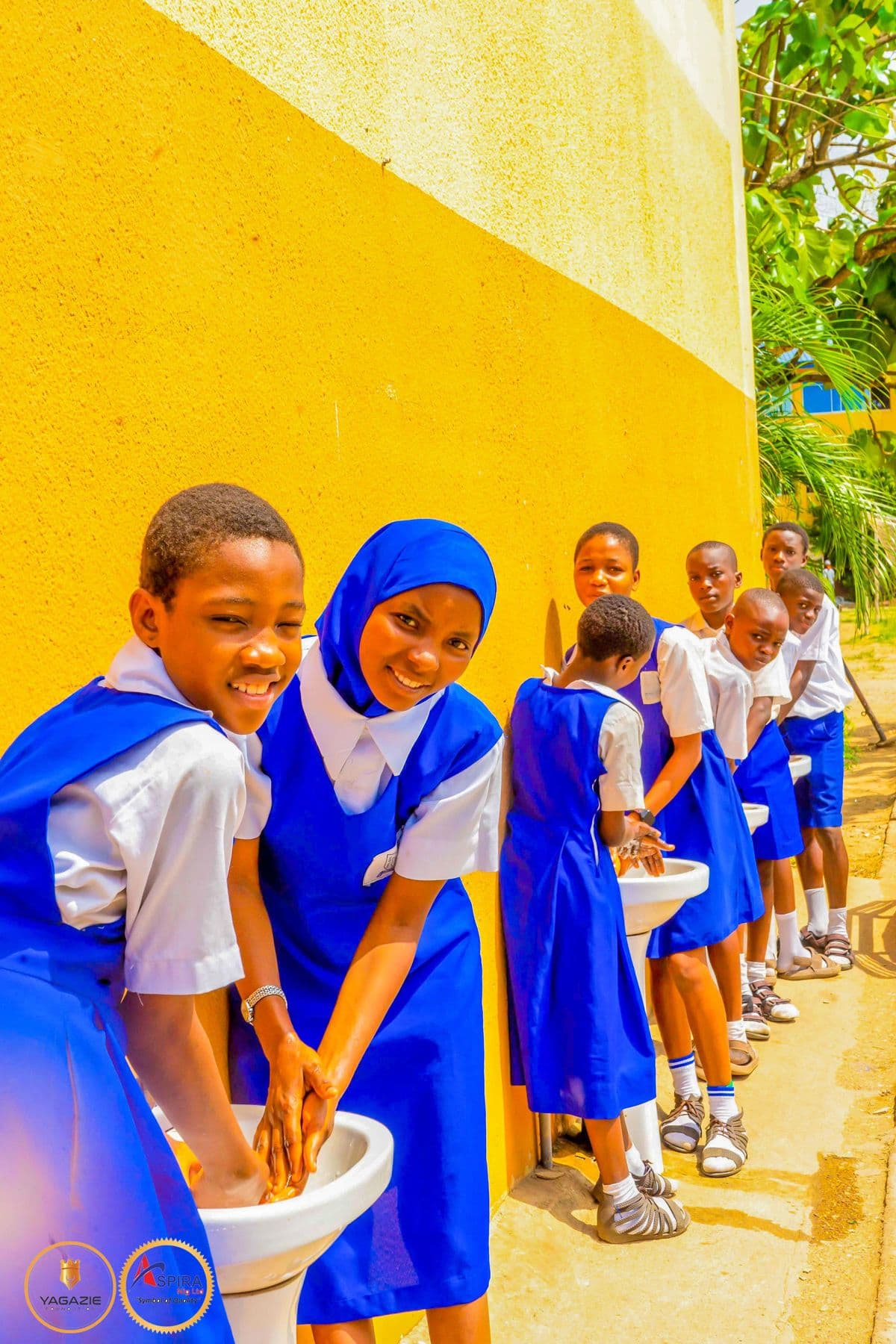Students queue to wash their hands