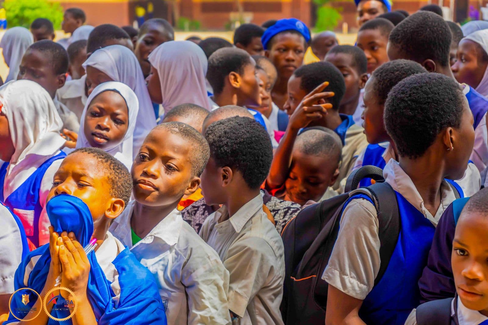 Students press forward to watch the hand-washing demonstration