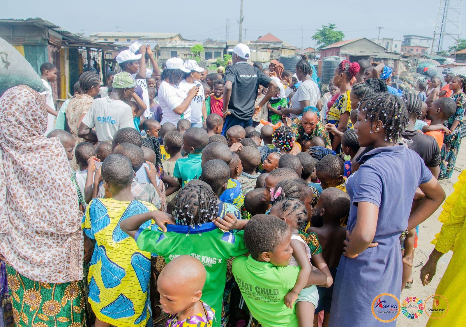 Children and mothers wait for their food packs