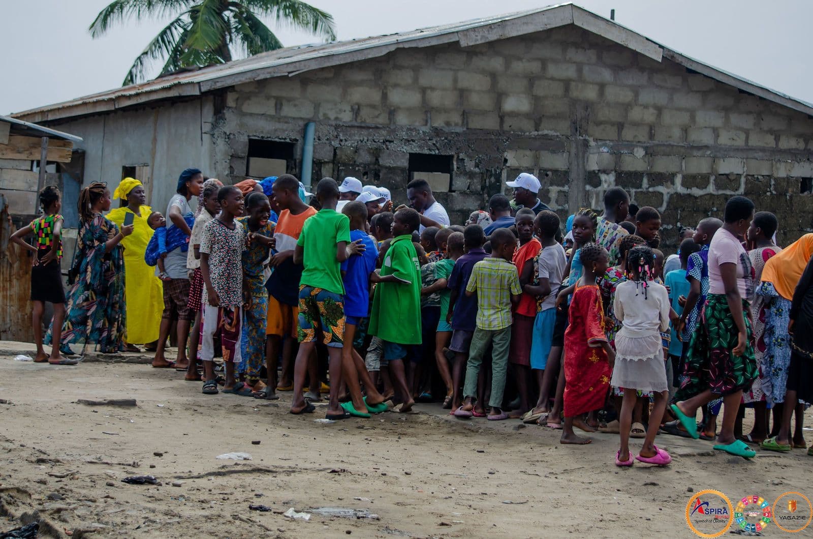 Residents line up along a wall for the distribution
