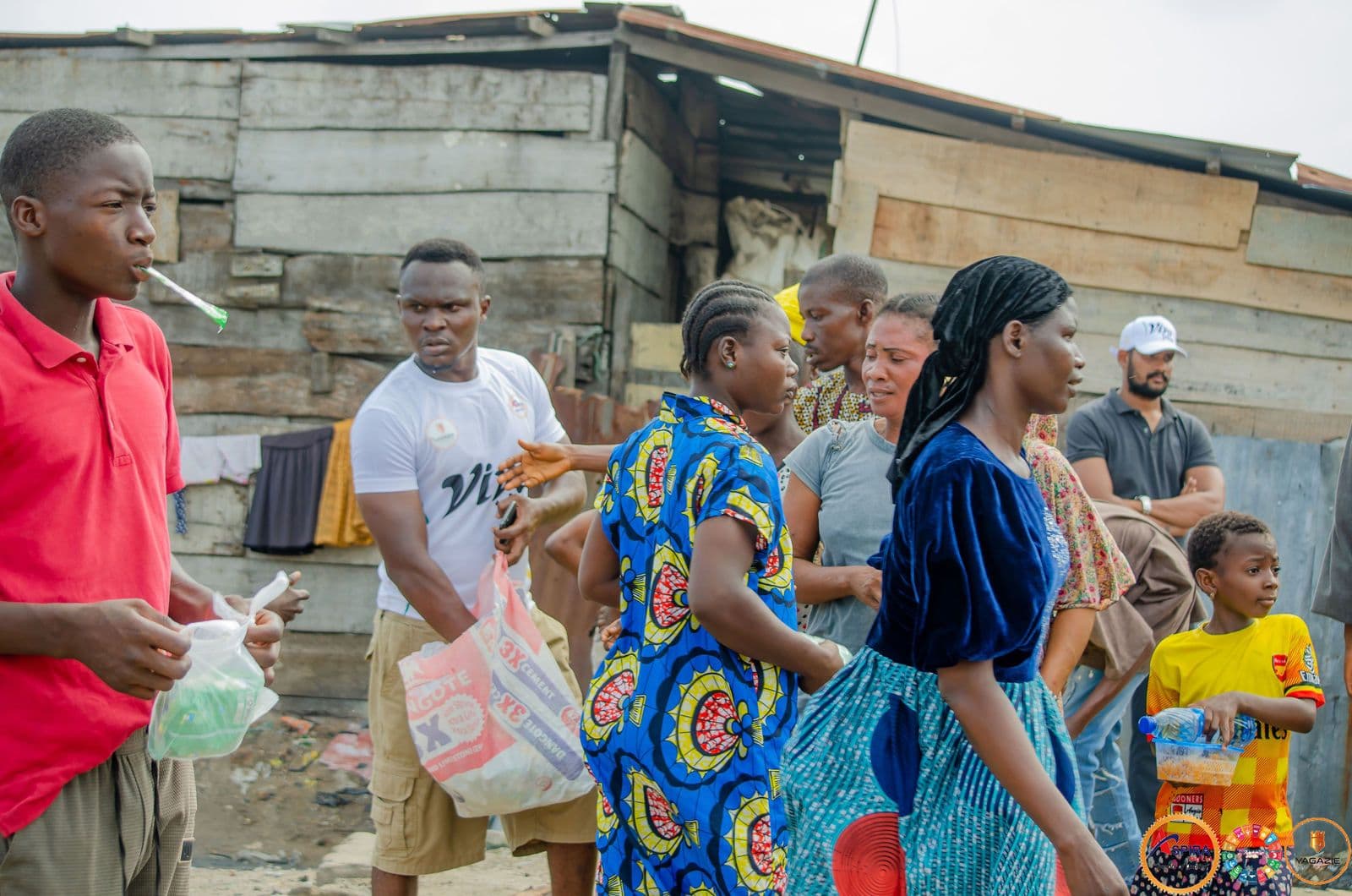 Volunteers distribute food packs to residents